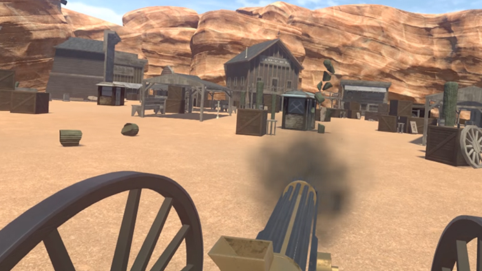 Screenshot of a western town - the player stands at a large gattling gun and is firing at a cactus, which is explosing into small pieces.